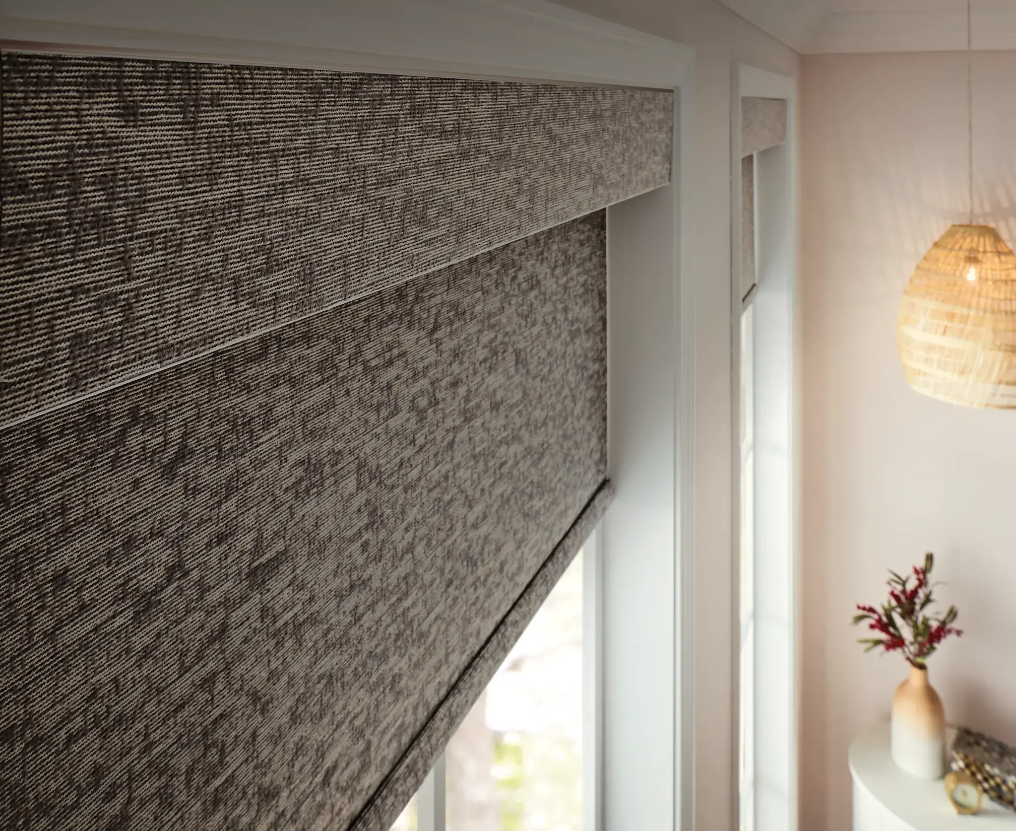 Close-up of various roller shade fabric swatches showing texture and opacity levels